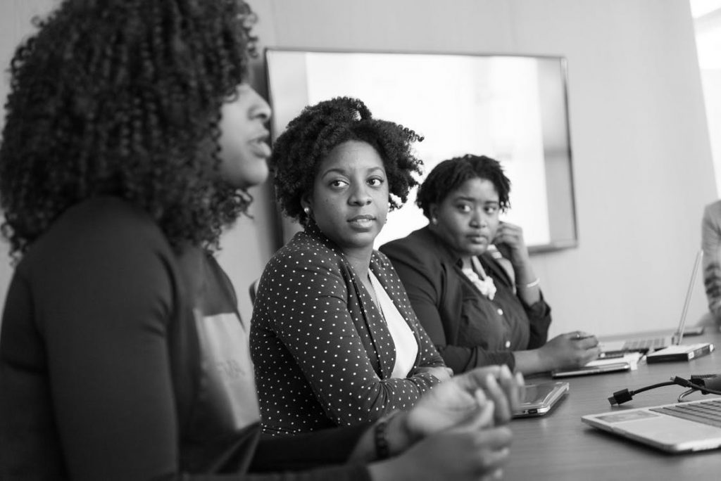 Black Woman in discussion with her Colleagues