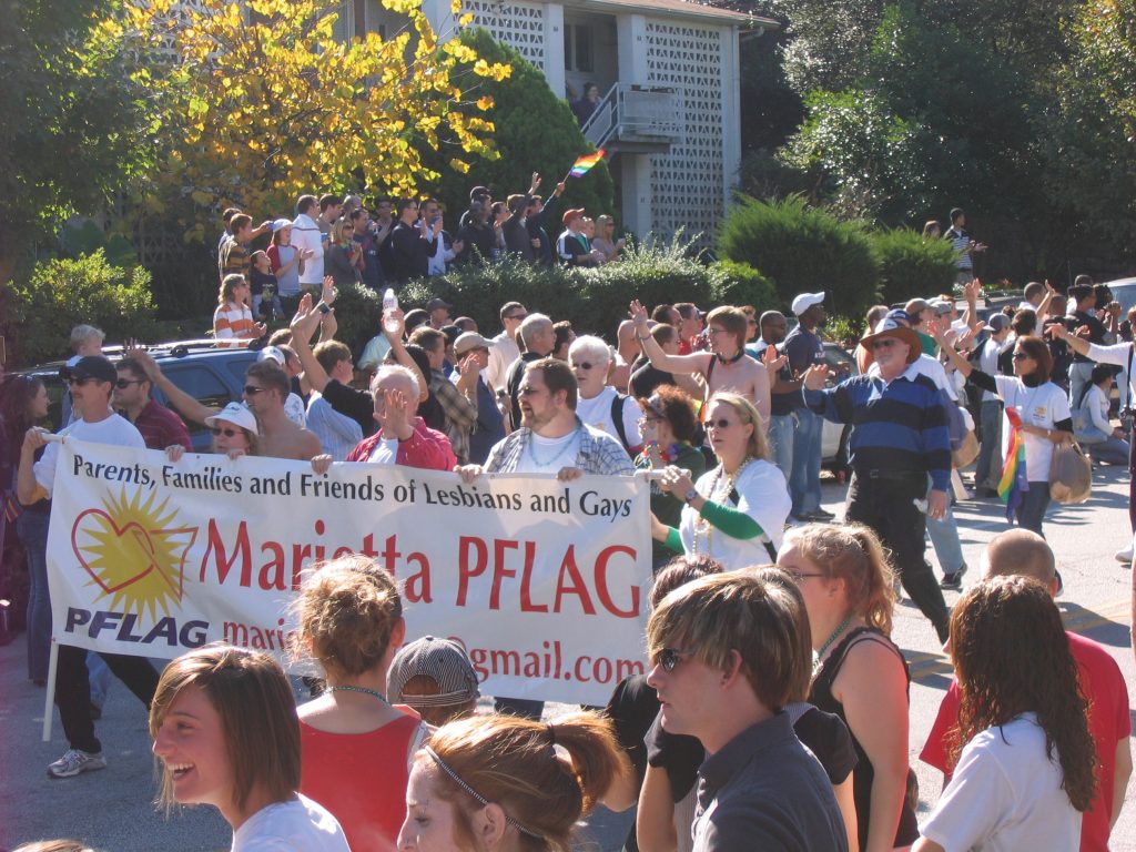 A pride parade featuring the group PFLAG, parents, families, and friends of lesbians and gays.