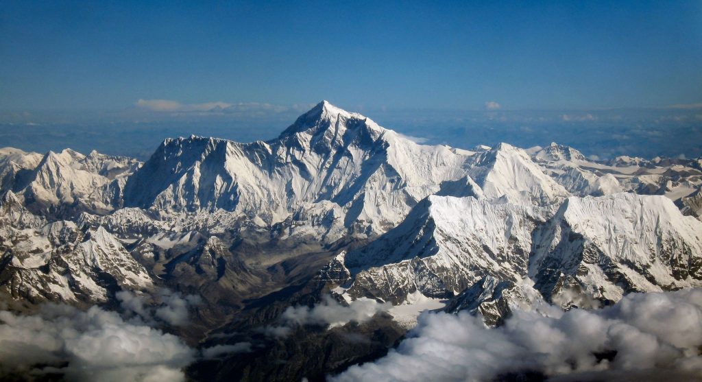 Aerial view of snow-covered Mt. Everest among the Himalayan mountain range.