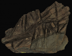 Komatiite Interactive Model. Komatiite is a dark greenish rock with bladed black/brown minerals.