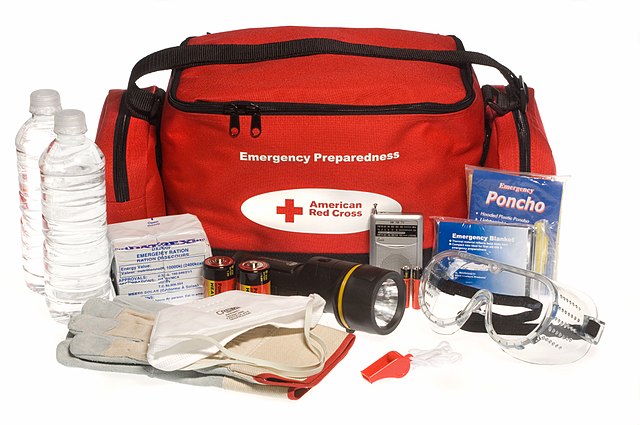 A standard emergency preparedness kit shown by the Red Cross that contains first aid supplies, water, personal protective gear and a flashlight.