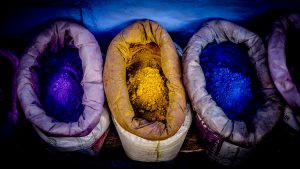 Image of baskets holding mineral-derived pigments, purple, ochre, and intense blue