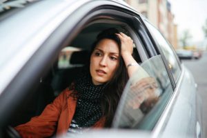 Woman in car visibly frustrated