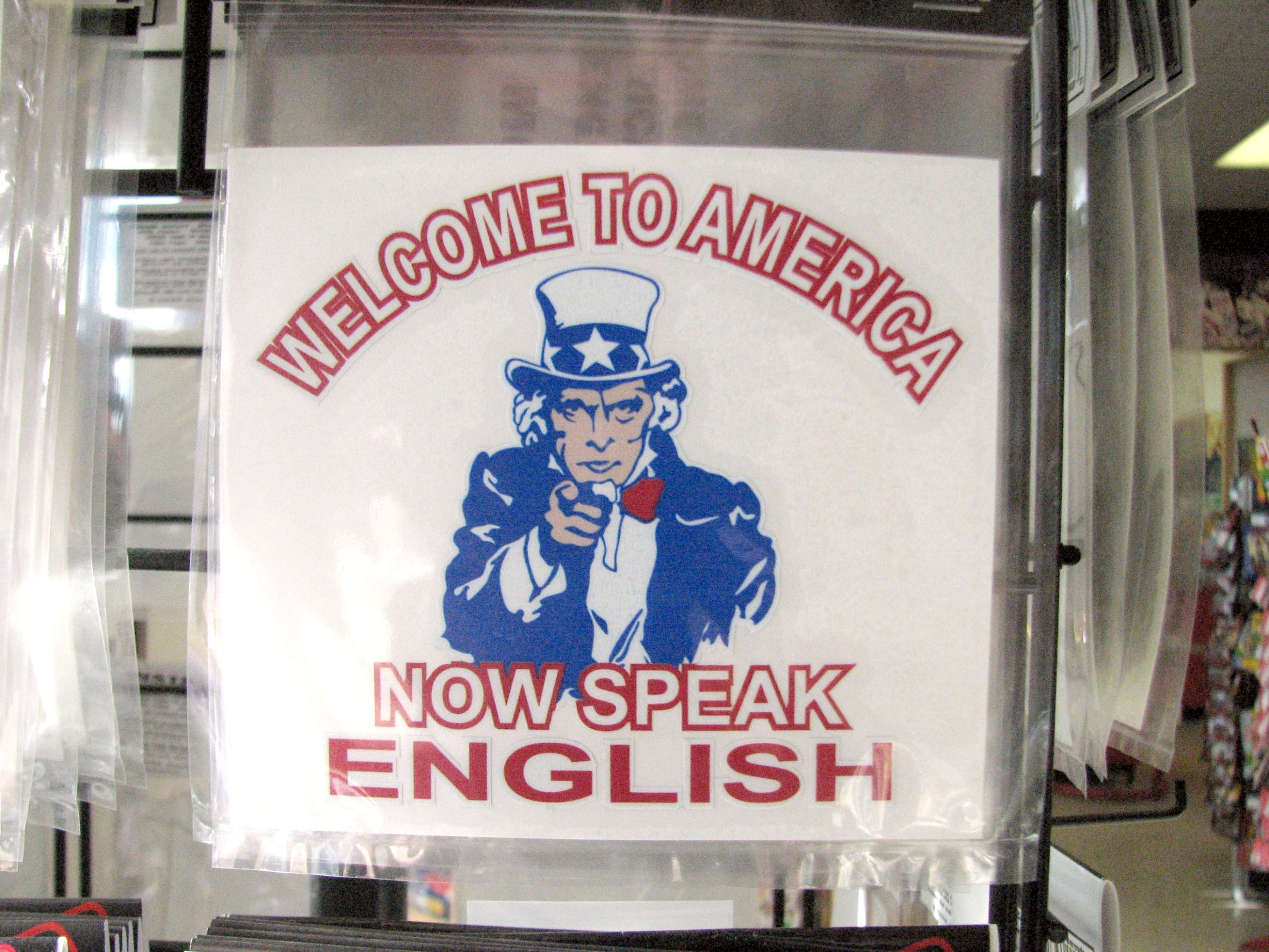 A sign stating Welcome to America Now Speak English