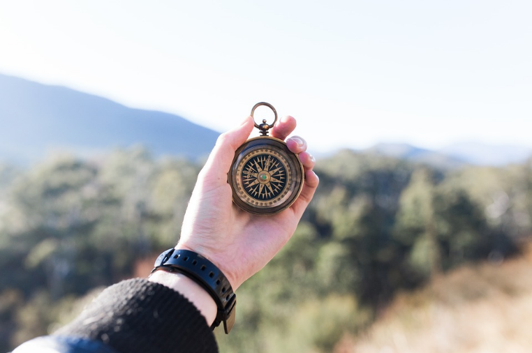 hand holding compass outside