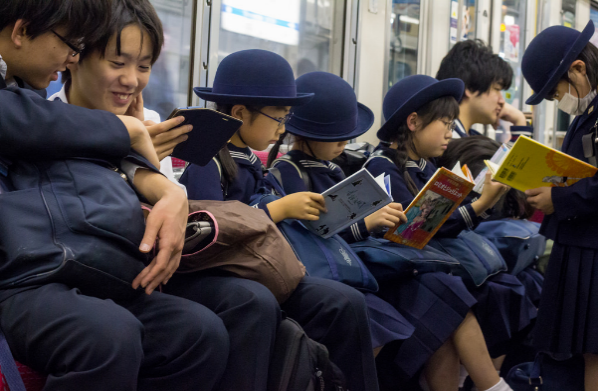 group of Asian teens sitting and reading