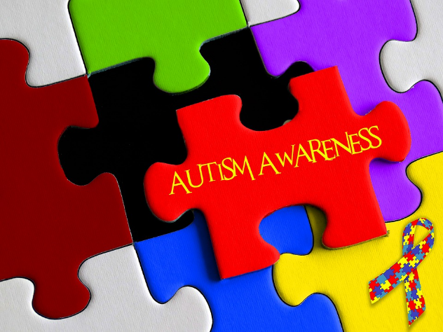 Puzzle pieces with the words "autism awareness" written on one.