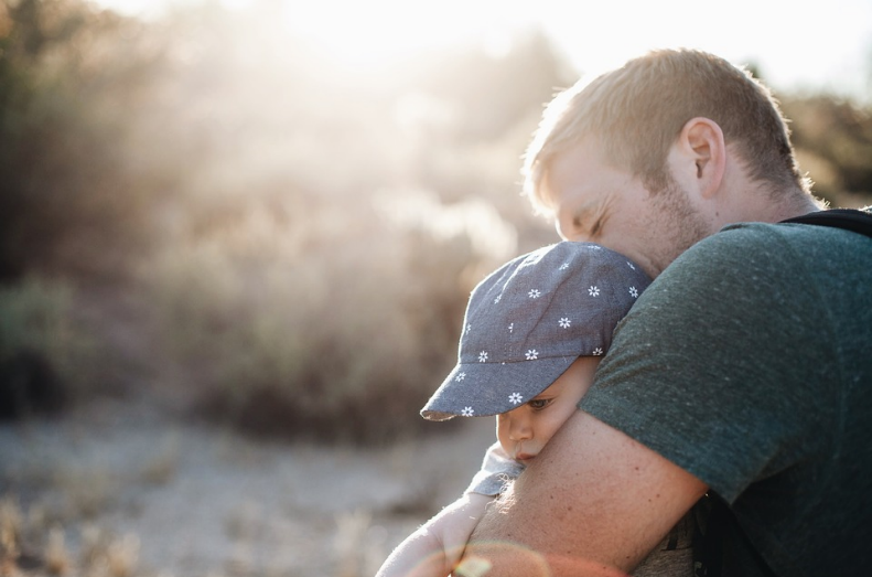 adult hugging young child