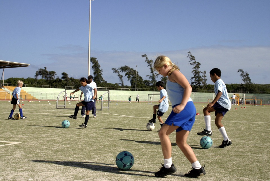 kids doing soccer drills on field