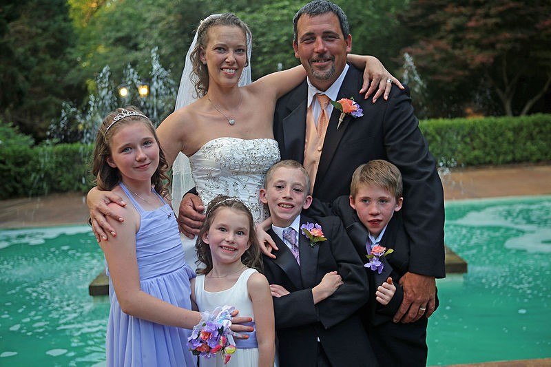 bride and groom with 4 children