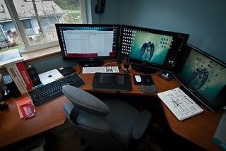 Image of desk with 3 monitors