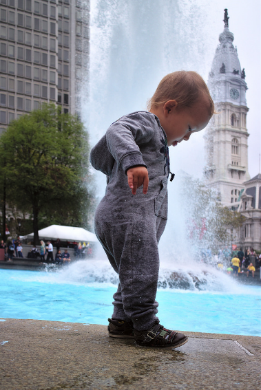 young child walking outside