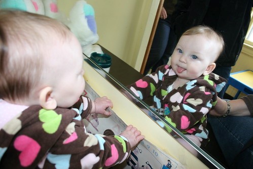 toddler looking at self in mirror