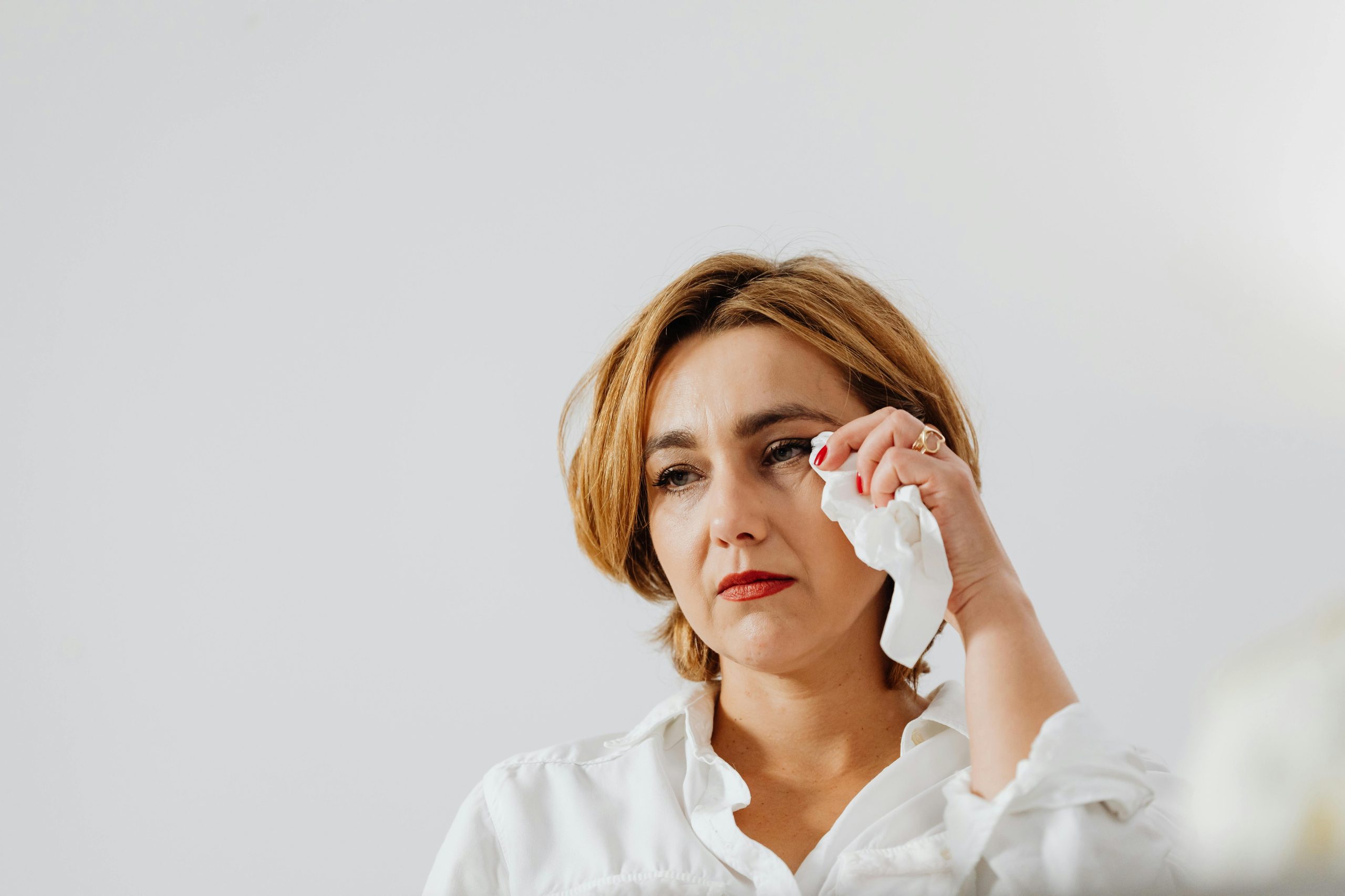 Woman in White Button Up Shirt Holding a Tissue Paper