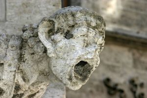 Photo of A limestone statue that has been eroded by acid rain