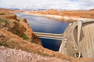 Photo of a large dam on the Colorado River with an artificial lake built up behind the dam