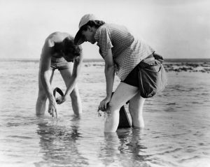 Photo of man and woman standing in shallow water
