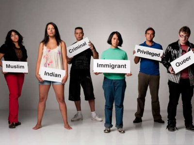 Six individuals who are holding signs with words that describe how they are stereotyped.