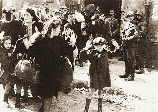 Jews being forcibly evacuated from their homes in Warsaw by Nazi soldiers.