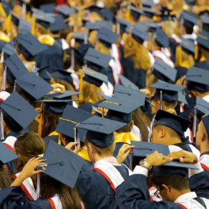 A crowd of students wearing college graduation regalia.