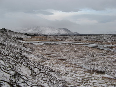 Cold barren climate; mountain in the far distance covered in snow.