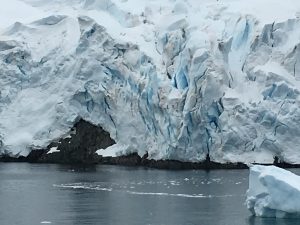 A glacier slowly flows into the ocean, Antarctica.