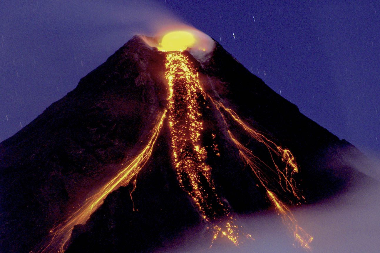 Conical and steep stratovolcano with bright orange lava flows