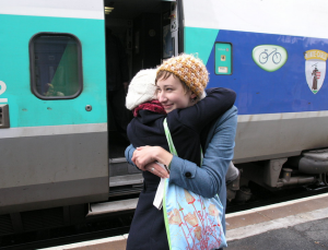 Two female friends hugging and saying goodbye