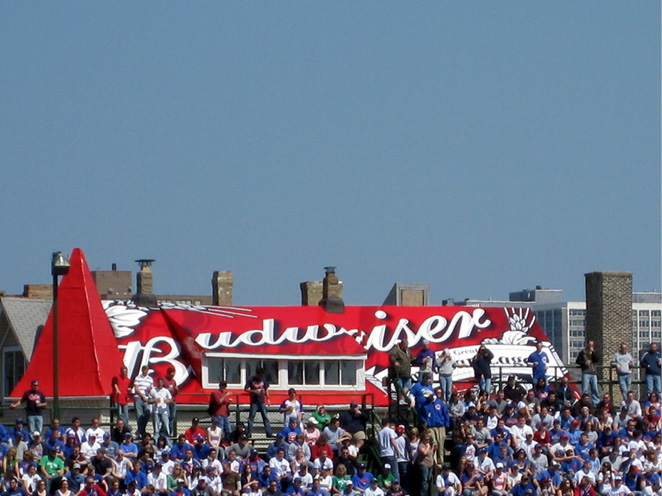 A crowd stands in front of a Budweiser logo