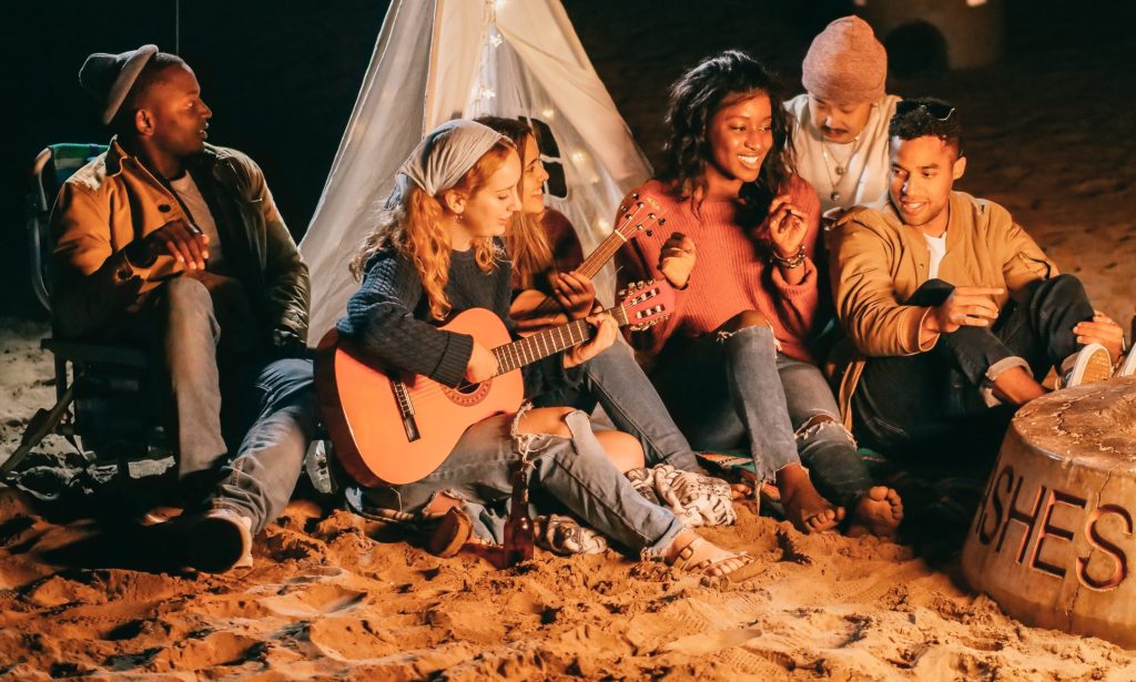 Group of Friends Sitting on Beach Sand