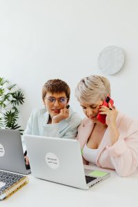 One Woman Looking at another Woman Talking on the Phone