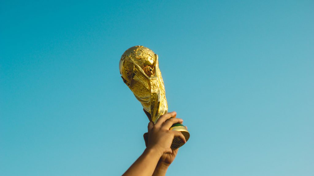 A person holding a gold trophy