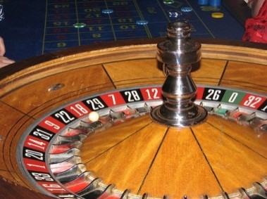 A roulette wheel with 38 spaces, 18 red, 18 black, and 2 green, the pill is set on red 18