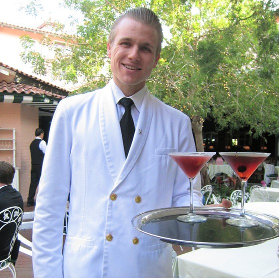 Server holding tray with two cocktails