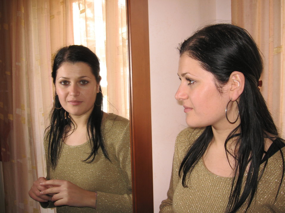 Woman looking in mirror