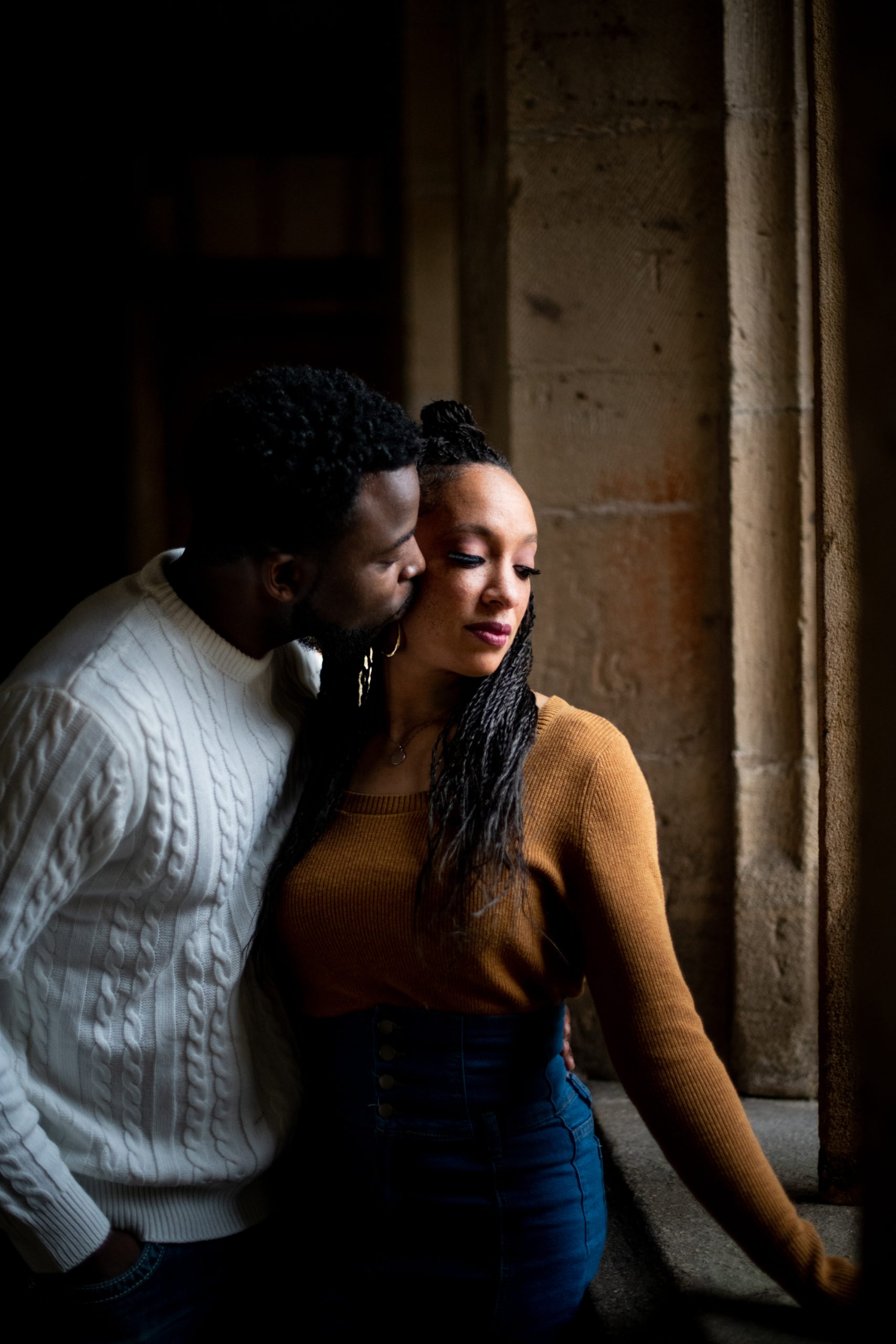 Man kissing woman's check.