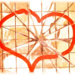 A heart drawn in marker displayed on a fractured glass background