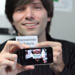 a man holding a smart phone that translates the card he is holding up