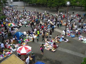 a flea market with customers and vendors outside