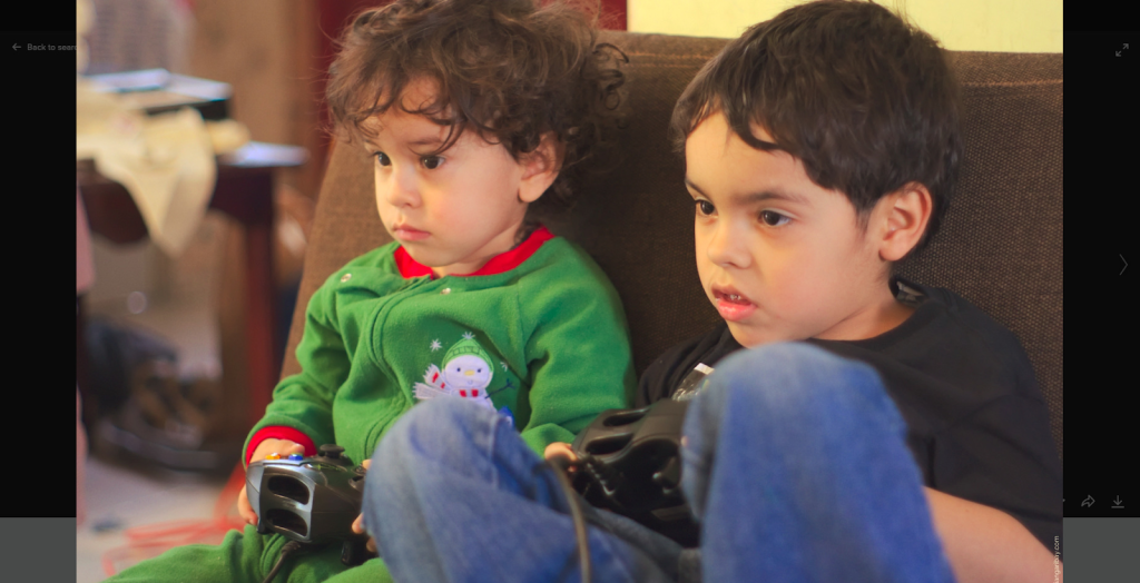 young children holding video game controllers