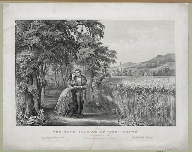 Couple walking on lane, along field of grain