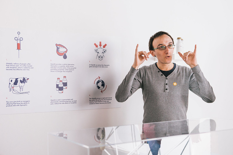 A man using his hand gesture during a presentation to guide for hearing impaired people.