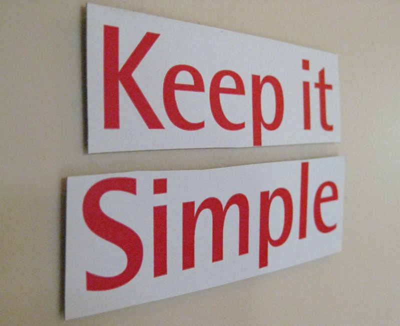 A sign that reads "Keep it Simple" in large, red letters.