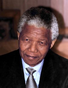A close up of Nelson Mandela wearing a suit from 1994.