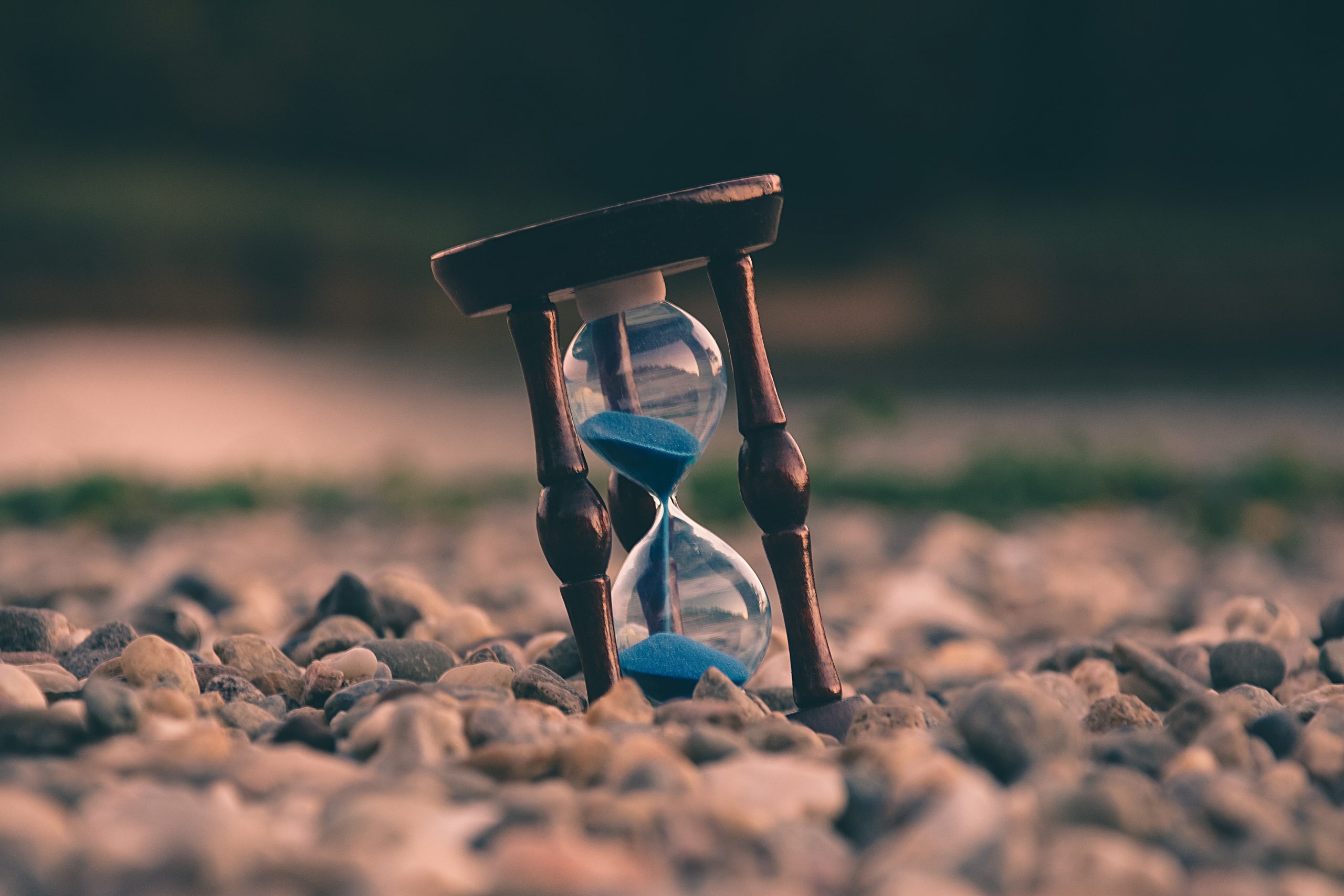 A brown and blue hourglass on the ground.