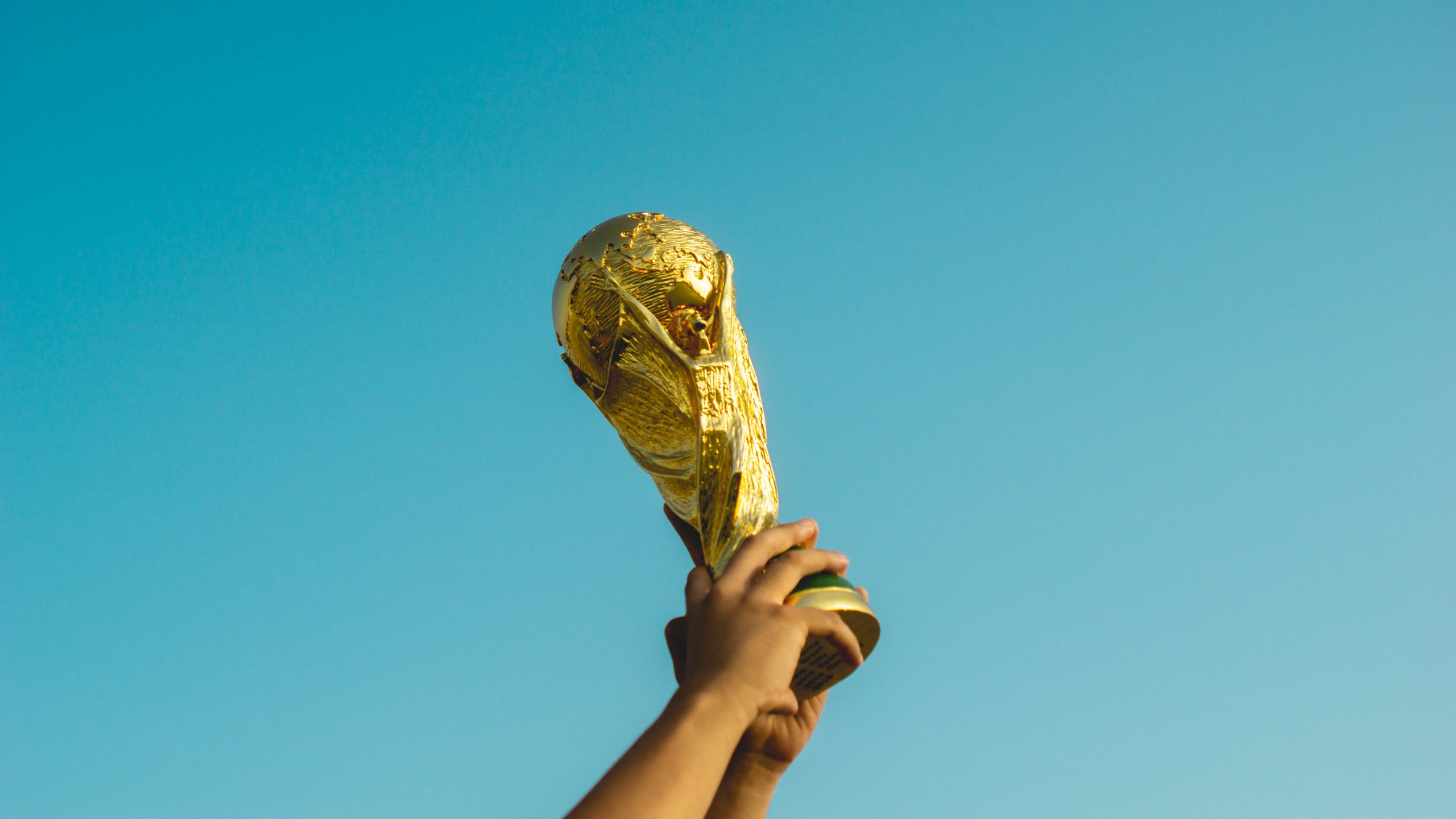 A person holding a gold trophy