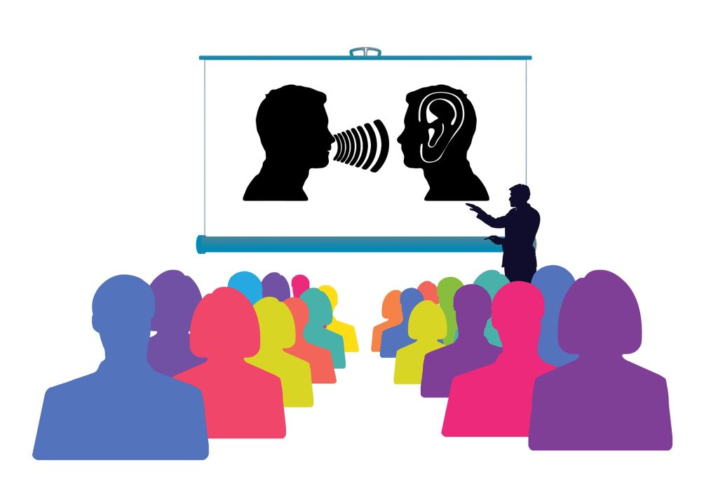 Clip art of an audience watching a presentation of a person talking while another person is listening.
