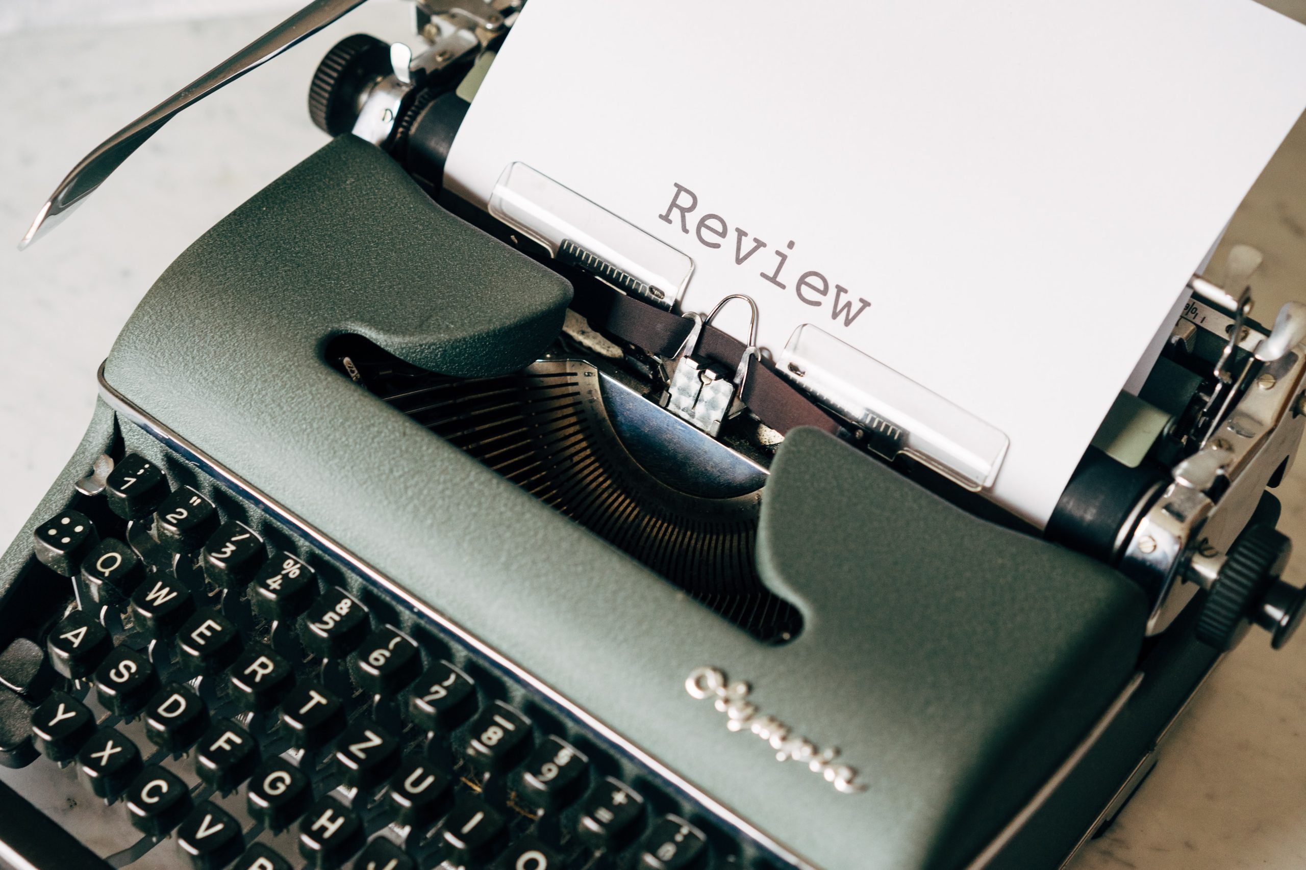 Vintage typewriter that typed the word "Review" on the loaded paper.