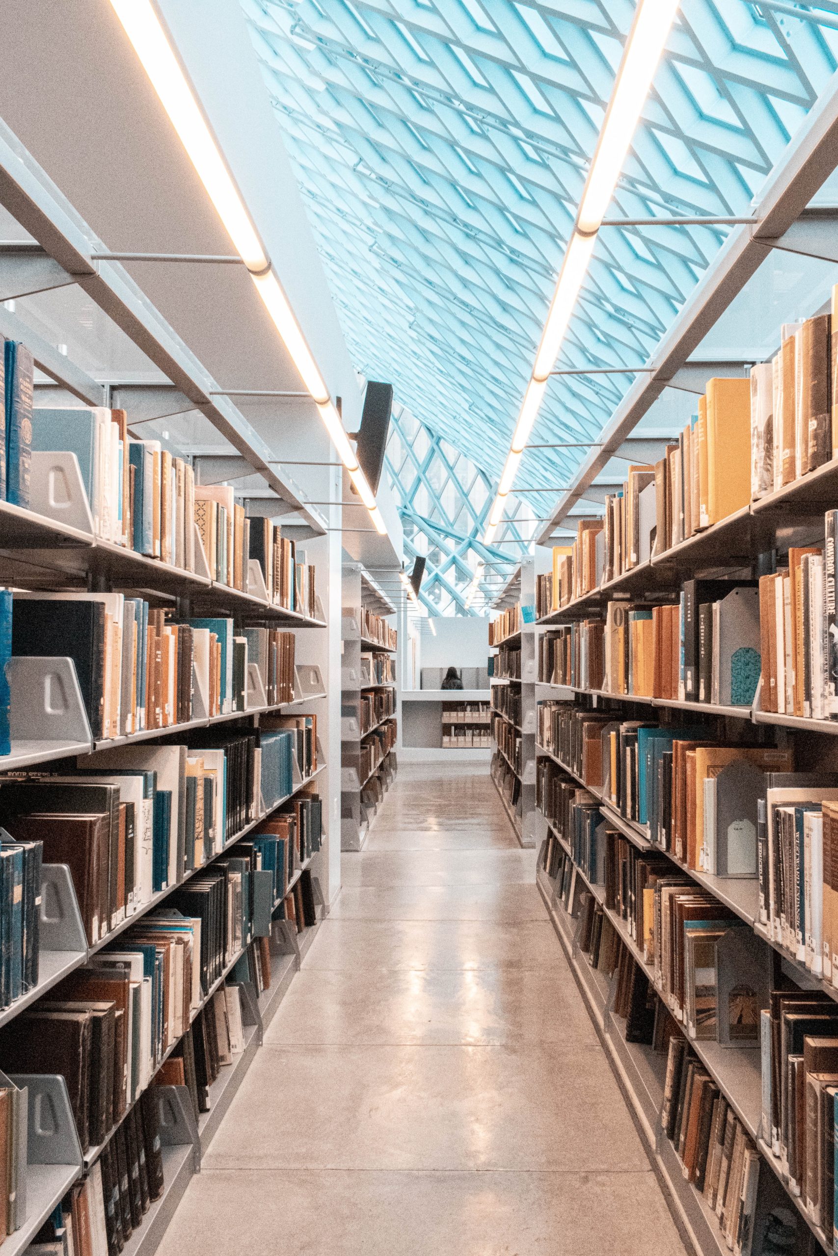 A library aisle with bookshelves on either side.
