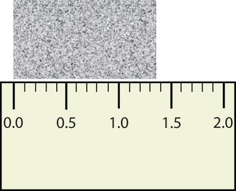 Image of a ruler measuring a grey rectangle, the measurement is 1.36 inches